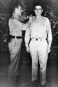 Maj. Gen. Clarence A. Tinker, commanding general of 7th Air Force, pins stars of Brig. Gen. on Col. William Farthing, Commander of the 7th Air Force Base Command, at Hickam Field, October 1, 1941. 