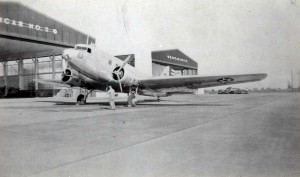 C-39 aircraft with 6th Fighter Squadron emblem in front of hangars at Hickam Field c1940.