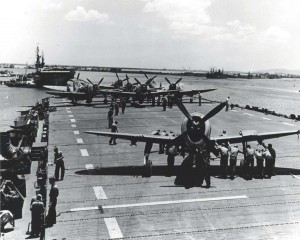 Republic P-45 Thunderbolts are pushed into place on deck of the aircraft carrier Natoma Bay which will ferry the planes from Pearl Harbor to Saipan, June 1, 1944. 