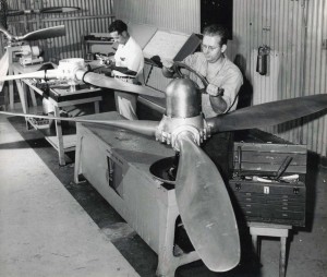 Hawaiian Airlines, March 1949. Mechanics work on propeller blades.