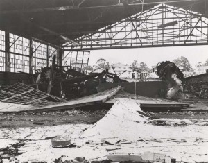 Close up view of wreckage in Hangar 1 at Wheeler Field, December 7, 1941. A P-26 aircraft is on left with a P-40 in background.   