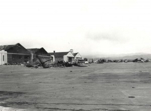 Aircraft wrecked on Wheeler Field flight line, December 7, 1941. In front is a demolished amphibian plane.   
