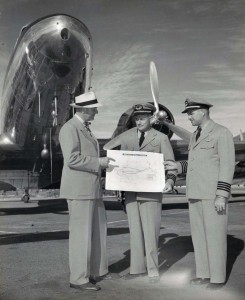 Hawaiian Airlines pilots show off route map at Honolulu International Airport, 1950s.