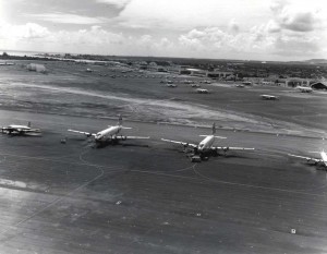 Flight line at Hickam Air Force Base, Hawaii, with C-124 aircraft in foreground, 1964.  