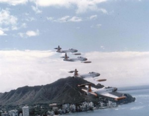 T-33A Shooting Star aircraft of the 15th Air Base Wing, Hickam Air Force Base, Hawaii, fly past Waikiki Beach, 1982.  