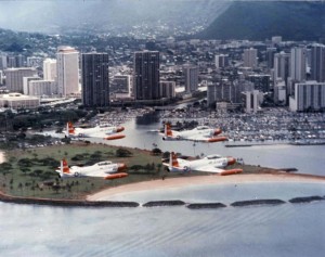 T-33A Shooting Stars from Hickam Air Force Base, Hawaii, fly in formation past Ala Moana Beach and the Waikiki Yacht Club, 1982.  