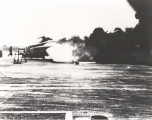 Smoke billows from burning B-17 on Hickam Field flight line, December 7, 1941.